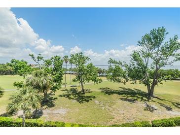 Beautifully landscaped grounds with mature trees and views of the bay create a serene outdoor environment at 2617 Cove Cay Dr # 401, Clearwater, FL 33760