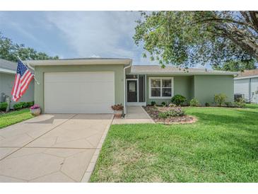 Charming single-story home featuring a well-maintained lawn and a two-car garage at 29436 Zeller Ave, San Antonio, FL 33576