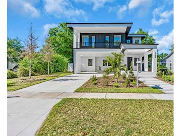 Modern two-story home with a sleek design, manicured landscaping, and a spacious open carport at 3175 10Th N Ave, St Petersburg, FL 33713