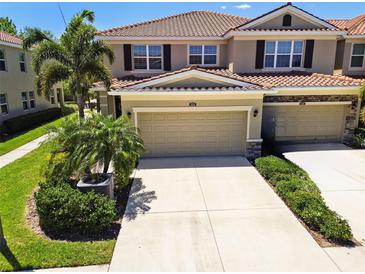 Beautiful two-story townhome with a tile roof, well-maintained landscaping, and a two-car garage at 5276 6Th N Way, St Petersburg, FL 33703