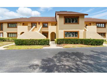 Charming townhouse featuring a well-maintained facade and mature landscaping at 8005 Bardmoor Pl # 102I, Seminole, FL 33777