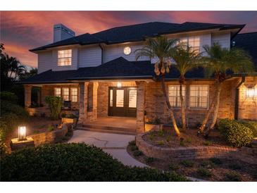 Charming front entrance featuring a brick facade and a professionally landscaped walkway at 101 Ponce De Leon Blvd, Belleair, FL 33756