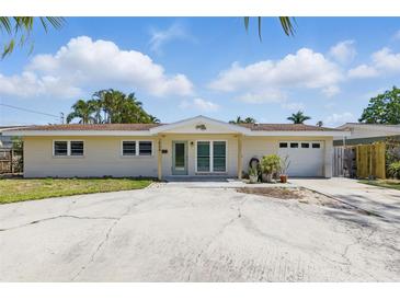 Charming single-story home with a spacious driveway and attached garage at 1524 Carson Ne Cir, St Petersburg, FL 33703