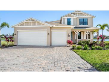 Charming home with a well-manicured lawn, a paved driveway, and a two-car garage at 2563 Ocean Breeze Ln, Clearwater, FL 33761