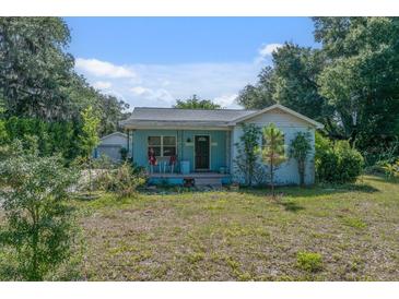 Charming single-story home with a welcoming front porch and well-manicured lawn at 6709 N 13Th St, Tampa, FL 33604