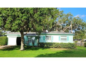 Charming single-story home with a well-manicured lawn and lush landscaping at 7336 20Th N St, St Petersburg, FL 33702
