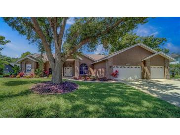 Charming single-story home with a well-manicured lawn and mature landscaping in a desirable neighborhood at 14073 Jennifer Ter, Largo, FL 33774