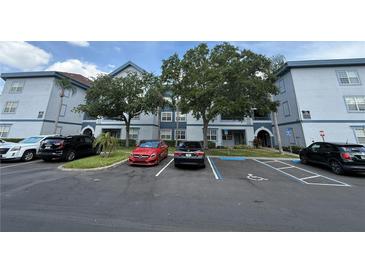 Inviting condo exterior featuring well-maintained landscaping and accessible parking at 1530 Villa Capri Cir # 302, Odessa, FL 33556