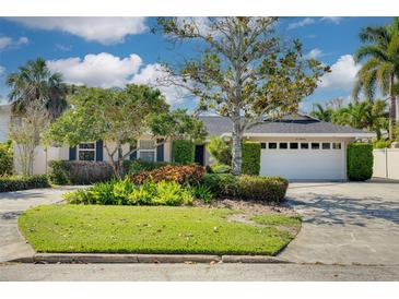 Charming single-Gathering home with mature landscaping, a well-manicured lawn, and a two-car garage at 219 Miramar Ne Blvd, St Petersburg, FL 33704