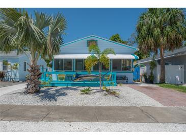 Charming beach house with a playful marlin decoration and an inviting, bright blue, covered front porch at 2613 Upton S St, Gulfport, FL 33711