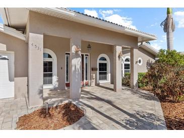 Inviting front entrance with arched windows, neutral color palette, and updated brick pavers at 4531 44Th S St, St Petersburg, FL 33711