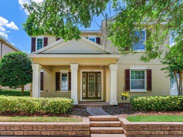 Charming two-story home boasts a covered porch with stately columns and well-manicured landscaping at 5409 Fishhawk Ridge Dr, Lithia, FL 33547