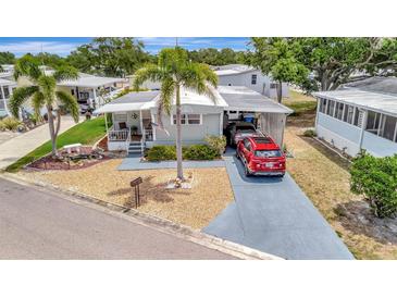 Charming single Gathering home with a well-manicured lawn and a two car covered parking spot at 123 Saint Kitts Way, Apollo Beach, FL 33572