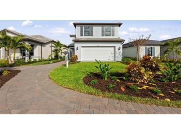 Charming two-story home with lush landscaping and a paved driveway at 16415 Sapphire Point Dr, Lakewood Ranch, FL 34211