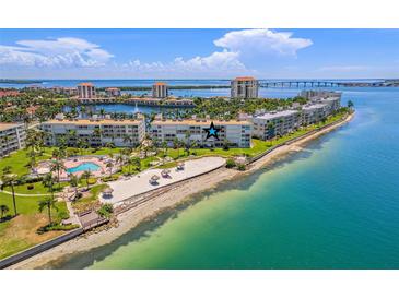 Aerial view of beachfront condos with a pool, sandy beach, and stunning bay views at 6081 Bahia Del Mar Cir # 452, St Petersburg, FL 33715