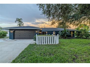 Charming single-story home with a well-manicured lawn and a two-car garage in a quiet neighborhood at 1211 64Th Nw St, Bradenton, FL 34209