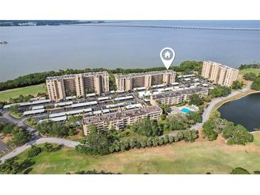 Breathtaking aerial view of the condos with golf course and water views at 2615 Cove Cay Dr # 409, Clearwater, FL 33760