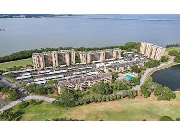 Beautiful aerial view of condo community featuring lush greenery and waterfront views at 2615 Cove Cay Dr # 409, Clearwater, FL 33760