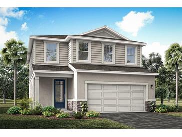 Charming two-story home featuring a two-car garage, landscaped yard, and a welcoming front entrance at 31350 Pendleton Landing Cir, Wesley Chapel, FL 33545