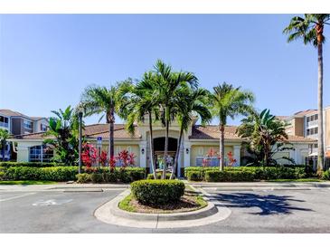 Community clubhouse featuring tropical landscaping, covered entrance, and convenient parking at 7901 Seminole Blvd # 1103, Seminole, FL 33772