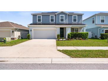 Charming two-story home with a well-manicured lawn and a two-car garage at 8595 Prairie Creek Dr, New Port Richey, FL 34655