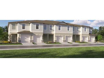 Charming townhomes with attached garages, manicured lawns, and inviting curb appeal at 10267 Trumpet Honeysuckle Way, San Antonio, FL 33576
