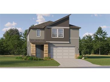 Charming two-story home featuring a modern design, a two-car garage, and a beautifully landscaped front yard at 11546 E 71St Ter, Palmetto, FL 34221