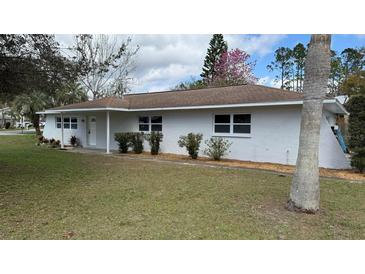 Charming single-story home featuring a well-maintained lawn and classic architectural details at 3188 Lake Saxon Dr, Land O Lakes, FL 34639