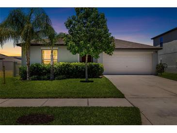 Charming single Gathering home showcasing a well manicured lawn and inviting curb appeal, perfect for families at 5208 Dandelion St, Apollo Beach, FL 33572