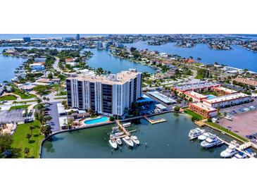 Aerial shot of the luxurious waterfront condo offering stunning views, pool, and boat docks at 10355 Paradise Blvd # 413, Treasure Island, FL 33706
