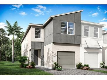 New construction home featuring modern architecture, neutral colors, a garage, and lush landscaping at 1144 Creek Valley Ct, Brandon, FL 33511