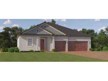 Charming single-story home featuring a two-car garage, brick driveway and a welcoming front porch at 12058 Violet Jasper Dr, Parrish, FL 34219