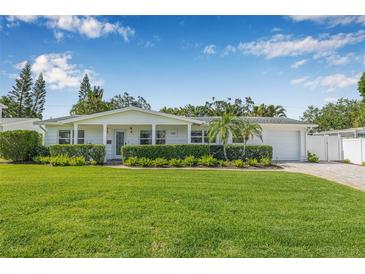 Charming single-story home with lush green lawn, manicured hedges, and a well-maintained front yard at 1404 84Th N Ave, St Petersburg, FL 33702