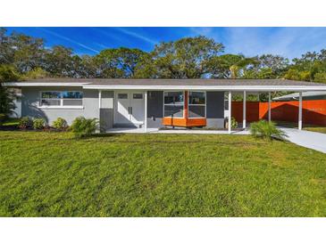 Charming single-story home with a well-manicured lawn and neutral paint scheme at 2042 Craft Ln, Sarasota, FL 34239
