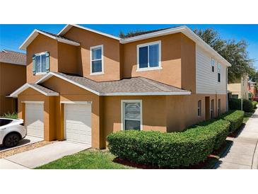 Two-story townhome with a private garage and beautiful landscaping at 2530 Sandy Beach Ln, Clearwater, FL 33763