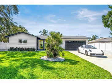 Charming single-story home with well-manicured lawn, modern exterior, and attached garage at 3436 Manatee Se Dr, St Petersburg, FL 33705