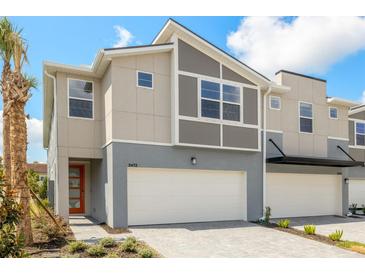 Contemporary townhome showcasing a two-car garage, modern architecture, and neutral color palette at 3472 Timber Crossing Ave, Brandon, FL 33511