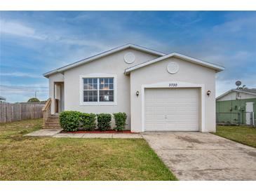 Charming single-Gathering home showcasing a well-maintained lawn and inviting curb appeal at 3730 Elmwood Dr, Holiday, FL 34691