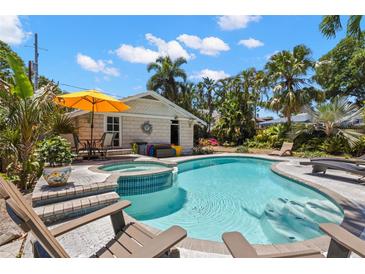 Sparkling pool and spa surrounded by lush tropical landscaping, with plenty of room for relaxing at 146 8Th Ne Ave, St Petersburg, FL 33701