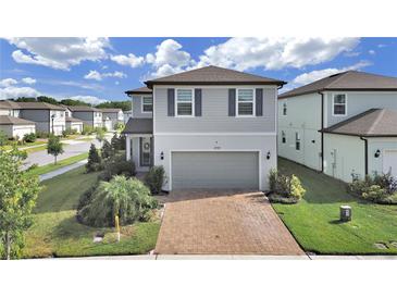 Charming two-story home with brick driveway and well-manicured landscaping at 17737 Everlong Dr, Land O Lakes, FL 34638
