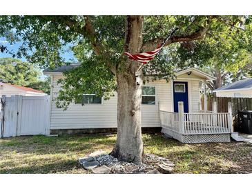 Charming single-story home with white siding, a blue front door, and a cozy porch at 3970 56Th Ave N, St Petersburg, FL 33714
