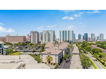 Aerial shot of condo complex with a cityscape backdrop and lush green landscaping at 501 Knights Run Ave # 1335, Tampa, FL 33602