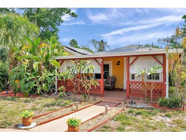 Charming home exterior with a cozy front porch, lush landscaping, and walkway, inviting you to relax and enjoy the outdoors at 1111 32Nd N St, St Petersburg, FL 33713