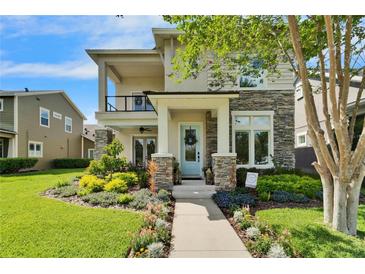 Charming home featuring a stone facade, manicured landscaping, and a welcoming light blue front door at 14204 Barrington Stowers Dr, Lithia, FL 33547