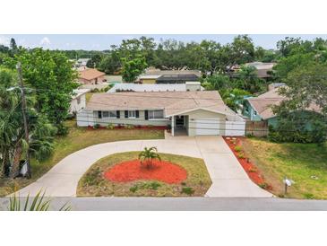 Charming single story home featuring a circular driveway and well-manicured landscaping at 14330 Oliver St, Largo, FL 33774