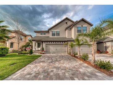 Stunning two-story home with a paver driveway and three-car garage, perfect for Gathering living at 4689 Wandering Way, Wesley Chapel, FL 33544