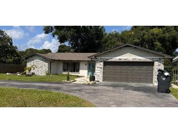 Charming single-story home featuring a two-car garage and well-maintained lawn at 620 Lithia Pinecrest Rd, Brandon, FL 33511