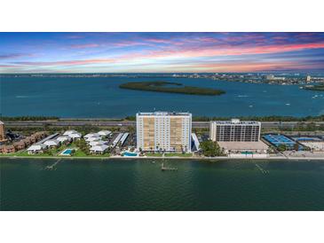 Breathtaking aerial view of waterfront condos, complex pools, and beautiful ocean bay at 7200 Sunshine Skyway S Ln # 4B, St Petersburg, FL 33711