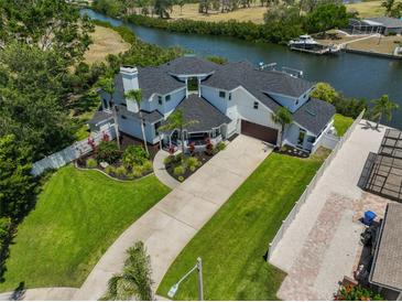 A beautiful two-story waterfront home with lush landscaping and a long driveway at 945 Bunker View Dr, Apollo Beach, FL 33572