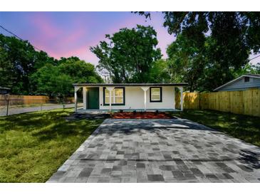 Charming single-story home with new landscaping, a freshly painted exterior, and a modern stone driveway at 10011 N Annette Ave, Tampa, FL 33612